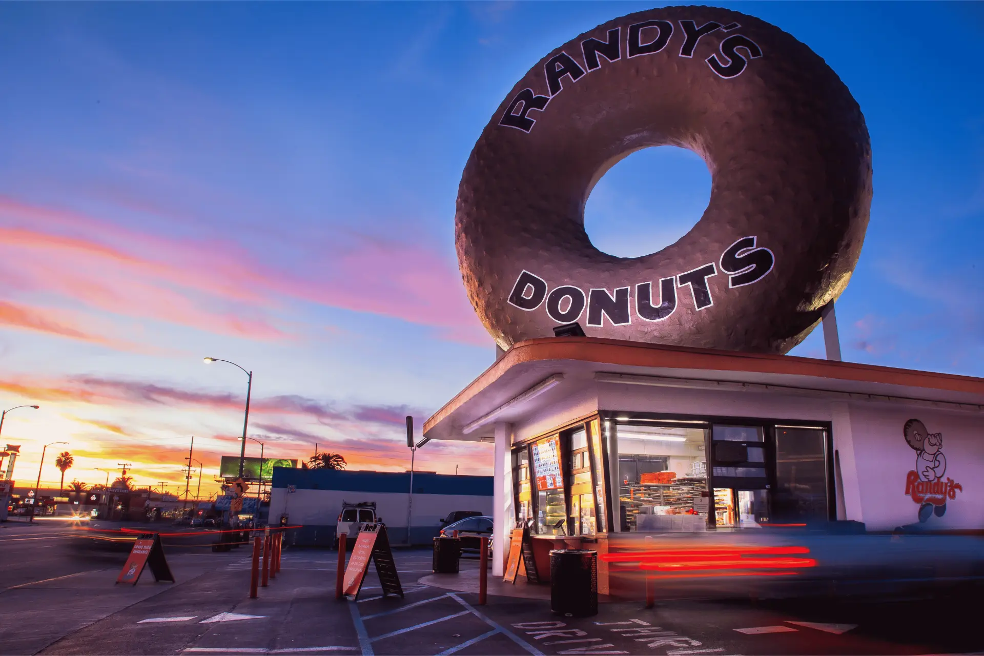 Randy's Donuts giant donut sign above the Inglewood shop at sunset