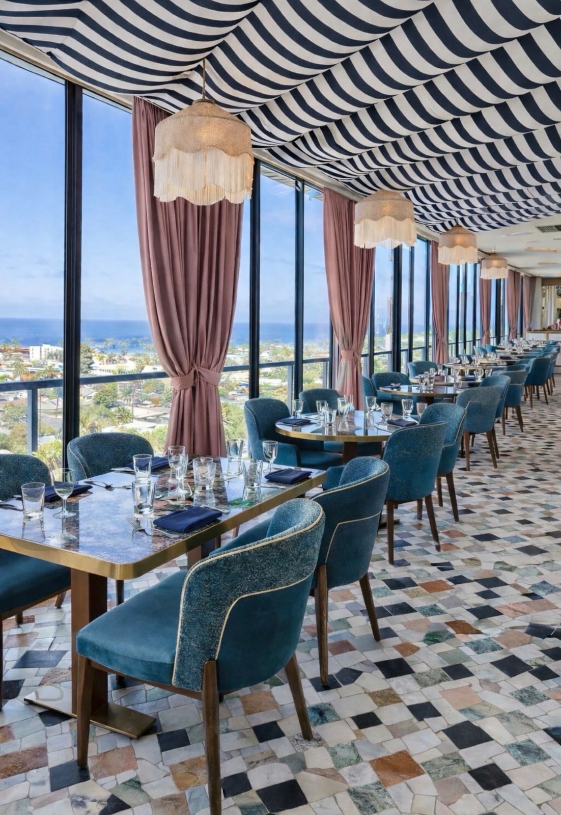 Aries rooftop dining room at Hotel La Jolla with striped canopy, teal chairs and ocean views